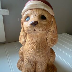 Charming Tan Dog Figurine with Red Santa Hat